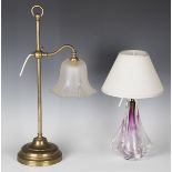 An early 20th century brass adjustable student's lamp with frosted glass shade and weighted base,