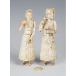 A pair of 19th century Indian carved ivory full-length figures of a lady and gentleman, height 18cm,