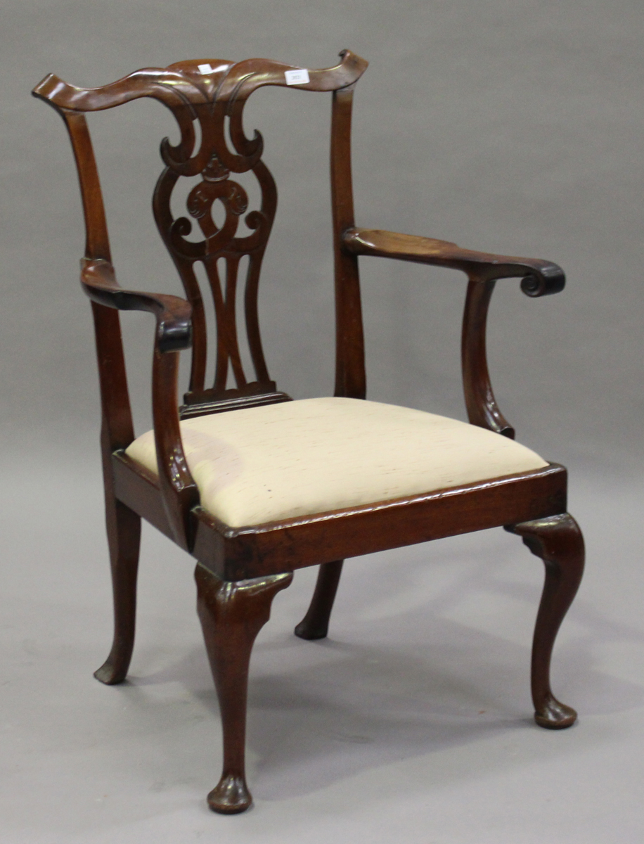 A George III Chippendale period mahogany pierced splat back elbow chair, on cabriole legs and pad