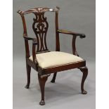 A George III Chippendale period mahogany pierced splat back elbow chair, on cabriole legs and pad