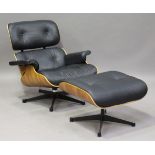 A modern black leather and walnut veneered plywood copy of an Eames lounge chair and matching