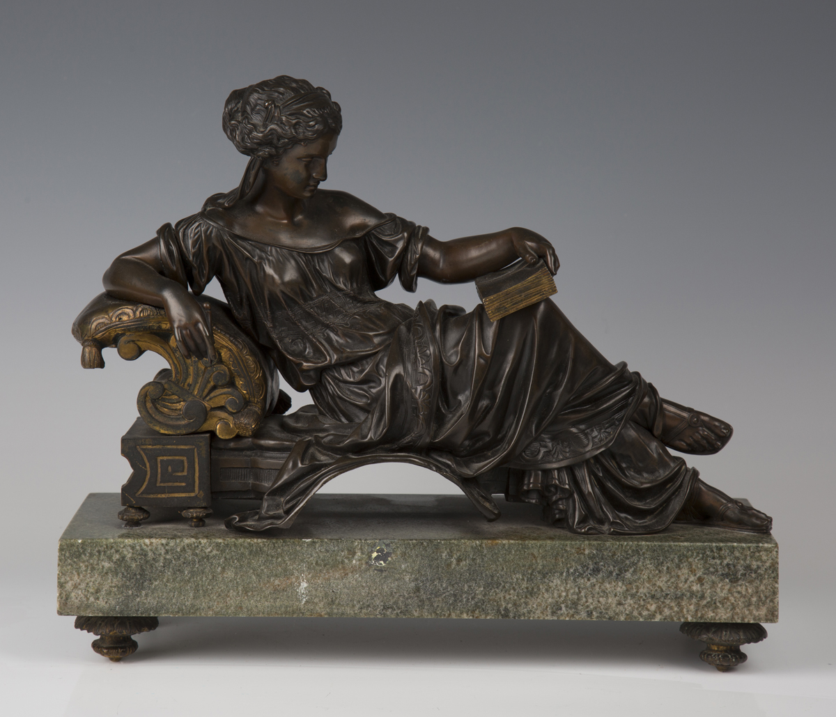 A late 19th century French brown and gilt patinated cast bronze figure of a Classical lady