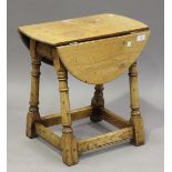 An early 20th century pale oak drop-flap occasional table, on turned and block legs, height 48cm,