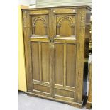 A mid-20th century Jacobean Revival oak bedroom suite by Lock of London, comprising two wardrobes, a