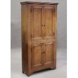A 19th century provincial oak two-tier side cupboard, enclosed by four panelled doors enclosing