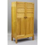A pair of 20th century cherry wood graduated wardrobes, both fitted with panelled doors enclosing