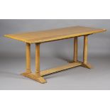 An early 20th century Heals pale oak Letchworth dining table, designed by Philip Tilden, the