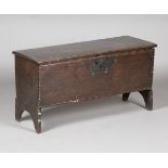 A mid-17th century oak six-plank boarded coffer, the lid with wire hinges above a chip carved