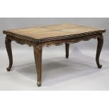 A 20th century French oak extending draw-leaf dining table, raised on cabriole legs, height 75.