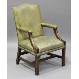 A 20th century George III style mahogany framed library armchair, upholstered in pale green leather,