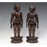 A pair of 20th century South Indian carved hardwood standing figures, height 47cm.Buyer’s Premium