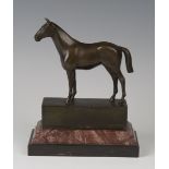 A late 20th century brown patinated cast bronze model of a horse standing four-square, bearing