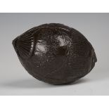 A 19th century carved coconut bugbear powder flask, one end typically worked with a mask with