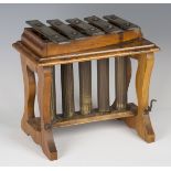 An early 20th century oak framed glockenspiel, on shaped supports, width 29cm.Buyer’s Premium 29.