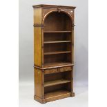 A 20th century reproduction walnut open bookcase with arched recess and two oak-lined drawers,