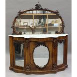 A late Victorian walnut mirror-back chiffonier with a white marble top above mirrored cupboard