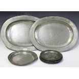 A selection of mainly 19th century pewter items, including two large oval platters, length 56cm,