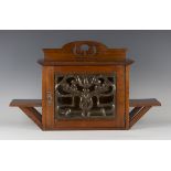 An Edwardian Arts and Crafts mahogany wall cabinet by Shapland & Petter of Barnstaple, the glazed