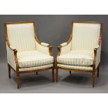 A pair of modern Louis XVI style showframe armchairs, upholstered in a cream stripe damask, the