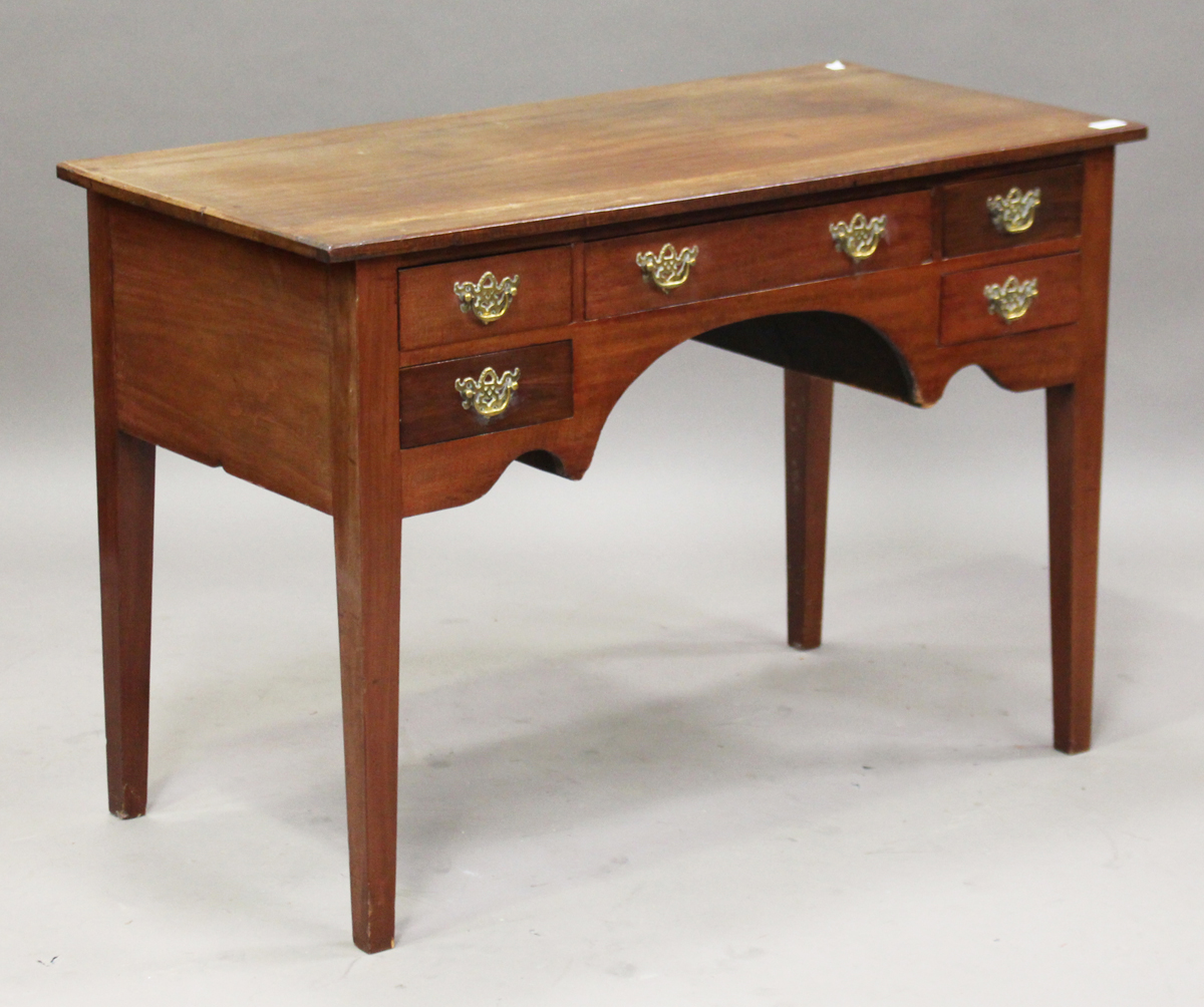 A 19th century mahogany kneehole writing table, fitted with an arrangement of five drawers, on
