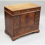 A George III and later mahogany side cabinet, fitted with a central cupboard and six drawers, height