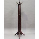 An Edwardian mahogany coat stand, on fluted tripod supports, height 205cm (some minor faults).