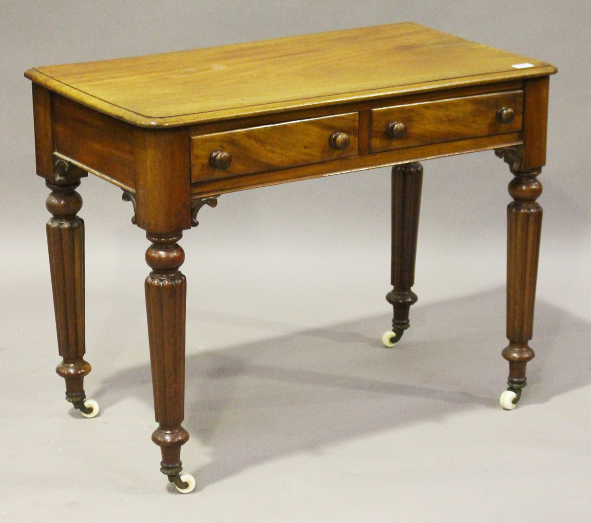 A Victorian mahogany side table, fitted with two frieze drawers, on reeded tapering legs and china