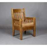 An early 20th century American Mission Arts and Crafts oak framed armchair, probably made by