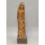 A 20th century carved hardwood figure group, modelled as the Madonna and Child, mounted on a