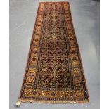 A Malayer runner, North-west Persia, early 20th century, the charcoal field with overall herati,