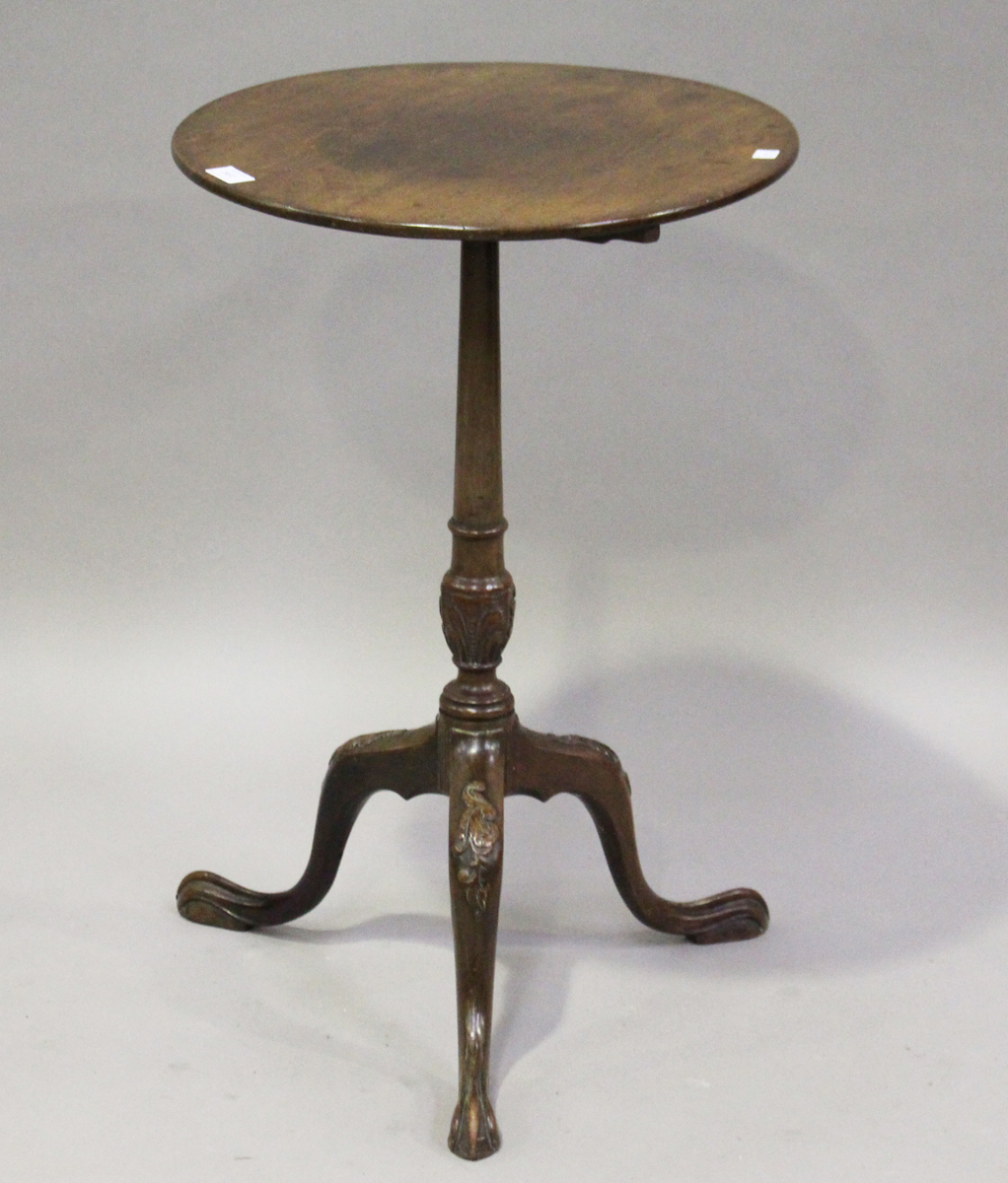 A late 19th century George III style mahogany wine table, raised on a carved stem and tripod legs,