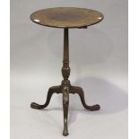 A late 19th century George III style mahogany wine table, raised on a carved stem and tripod legs,