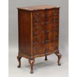 An early 20th century reproduction mahogany serpentine fronted chest of drawers, on cabriole legs,