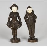 A pair of French Art Deco cast bronze and carved ivory figures of Pierrot and Pierette, modelled as