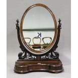 A late Victorian mahogany swing frame dressing table mirror, the serpentine base fitted with a