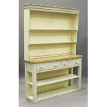 A 20th century cream painted pine dresser with shelf back above two short drawers, on block legs