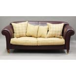 A modern maroon leather and chequered fabric settee, on turned legs and brass caps, height 85cm,