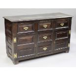 A mid-18th century oak dresser base, the moulded top above three drawers, two dummy drawers and