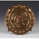 A late 19th/early 20th century Arts and Crafts copper charger, attributed to Norman and Ernest