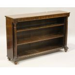 A George IV mahogany open bookcase, the two fixed shelves flanked by turned columns, on bun feet,