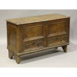 An 18th century stained pine mule chest, the hinged lid above two drawers, on shaped end supports,