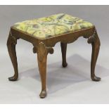 An early 20th century Queen Anne style walnut stool, the drop-in woolwork seat on scallop shell
