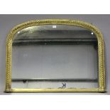 A Victorian giltwood arched overmantel mirror, decorated with a beaded and stiff leaf band, 83cm x