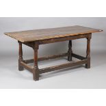 A mid-18th century provincial oak refectory table, the three-plank top above a single end drawer,