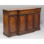 An early Victorian mahogany side cabinet, fitted with three drawers above arched panel doors, height