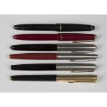 A group of six fountain pens, comprising five Parker pens and an Osmiroid 65, together with two