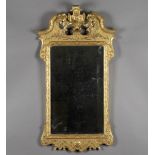 A fine George II style carved giltwood and gesso wall mirror, probably 19th century, the shaped