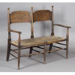 An Edwardian Arts and Crafts ash two-seat settee, designed by E.G. Punnett and made by William