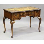 An early 20th century Queen Anne style walnut writing table, raised on carved cabriole legs,