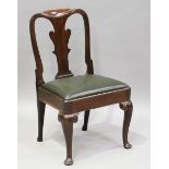 A George II mahogany side chair, the shaped splat back above a dark green leather seat, on carved